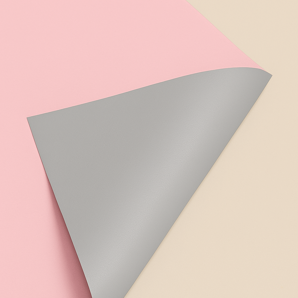 Gray paper sheet on a pink and beige background