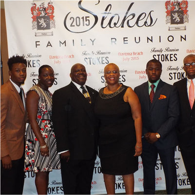 Group of people posing in front of a 'Stokes Family Reunion 2015' backdrop.