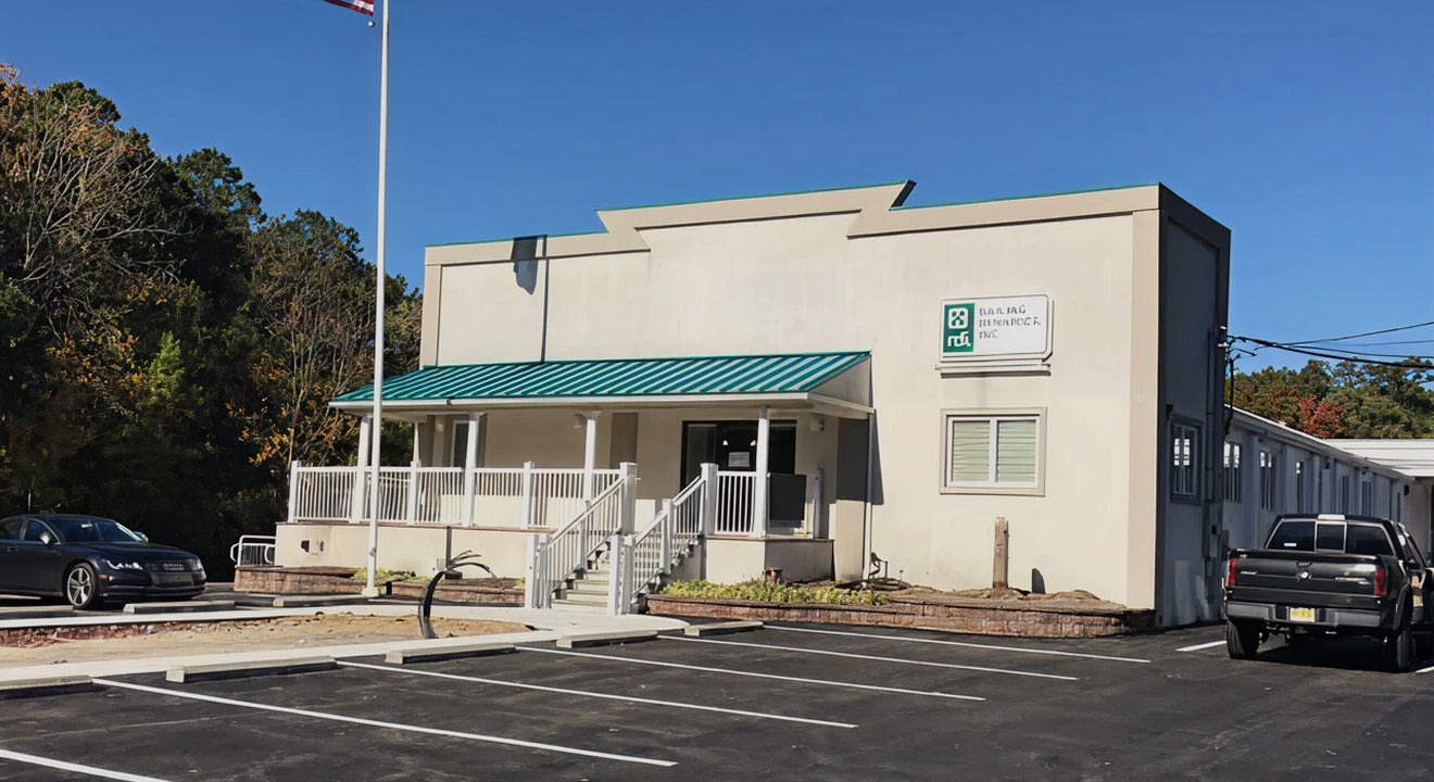 Building with a green awning and a truck parked in front