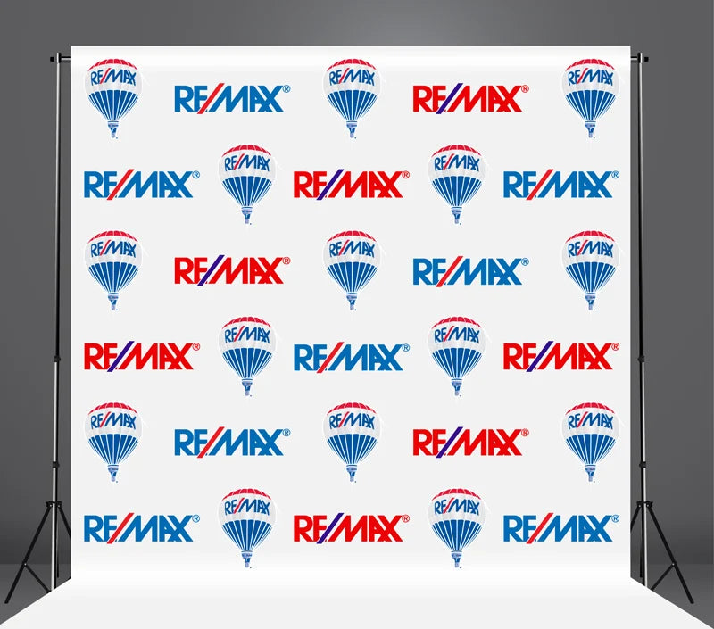 RE/MAX branded backdrop with multiple logos on a white background