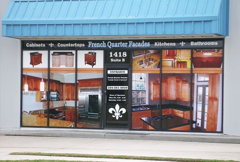 Storefront with a large window display of kitchen and bathroom fixtures, featuring a blue roof.